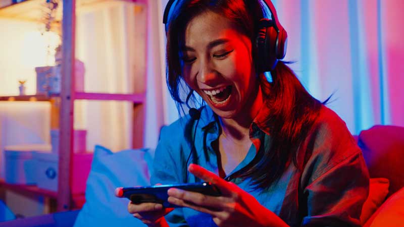 Female gamer smiling at phone