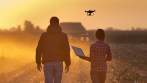 farmers using laptop and other technologies in a rural setting