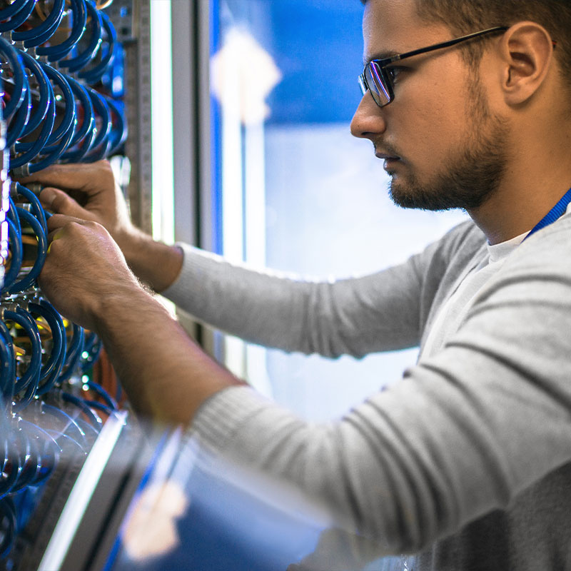 Man working on rack with wires and cables